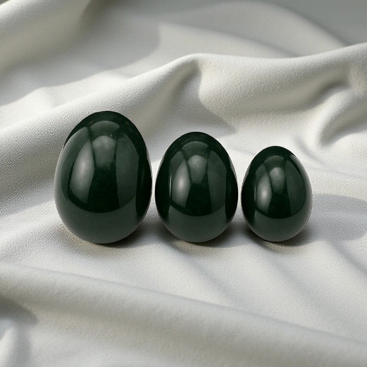 Jade nephrite Yoni eggs. A sacred practice for feminine strength, healing, and embodiment. from Gaiae Sydney.on white linen cloth