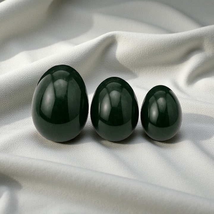 Jade nephrite Yoni eggs. A sacred practice for feminine strength, healing, and embodiment. from Gaiae Sydney.on white linen cloth