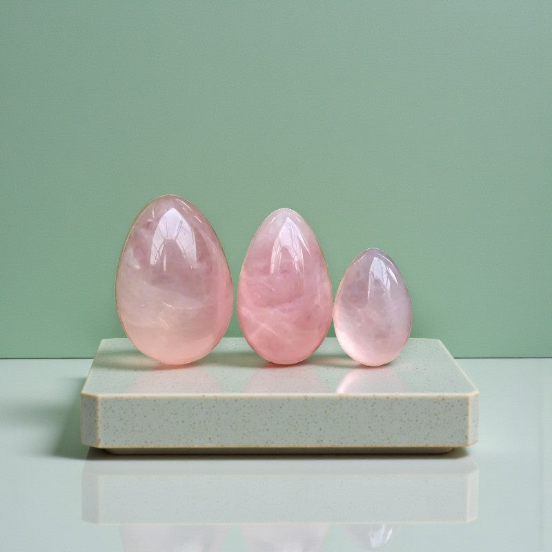 Rose quartz Yoni eggs. A sacred practice for feminine strength, healing, and embodiment. from Gaiae Sydney.on marble plate and green background