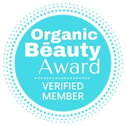 Organic Beauty Award Verified Member logo with a blue circle and white text on a light blue background