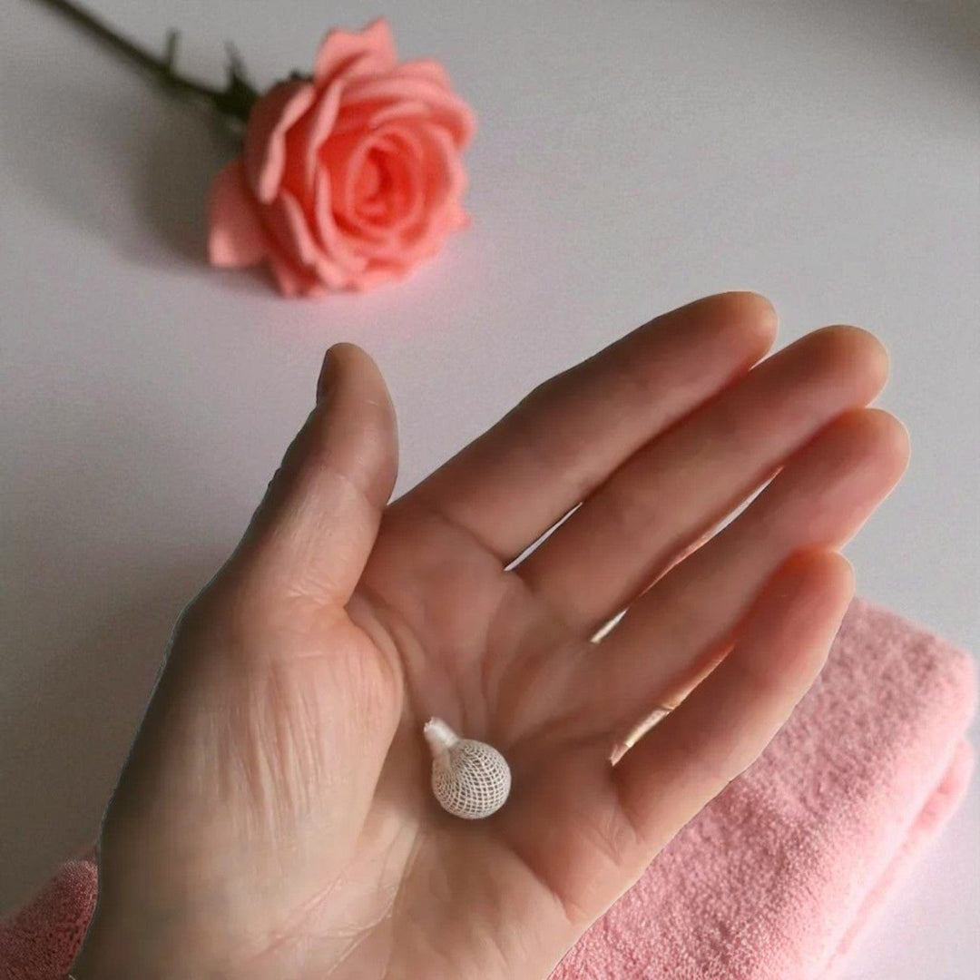 Gaiae Yoni Pearls in ladies hand with flower 